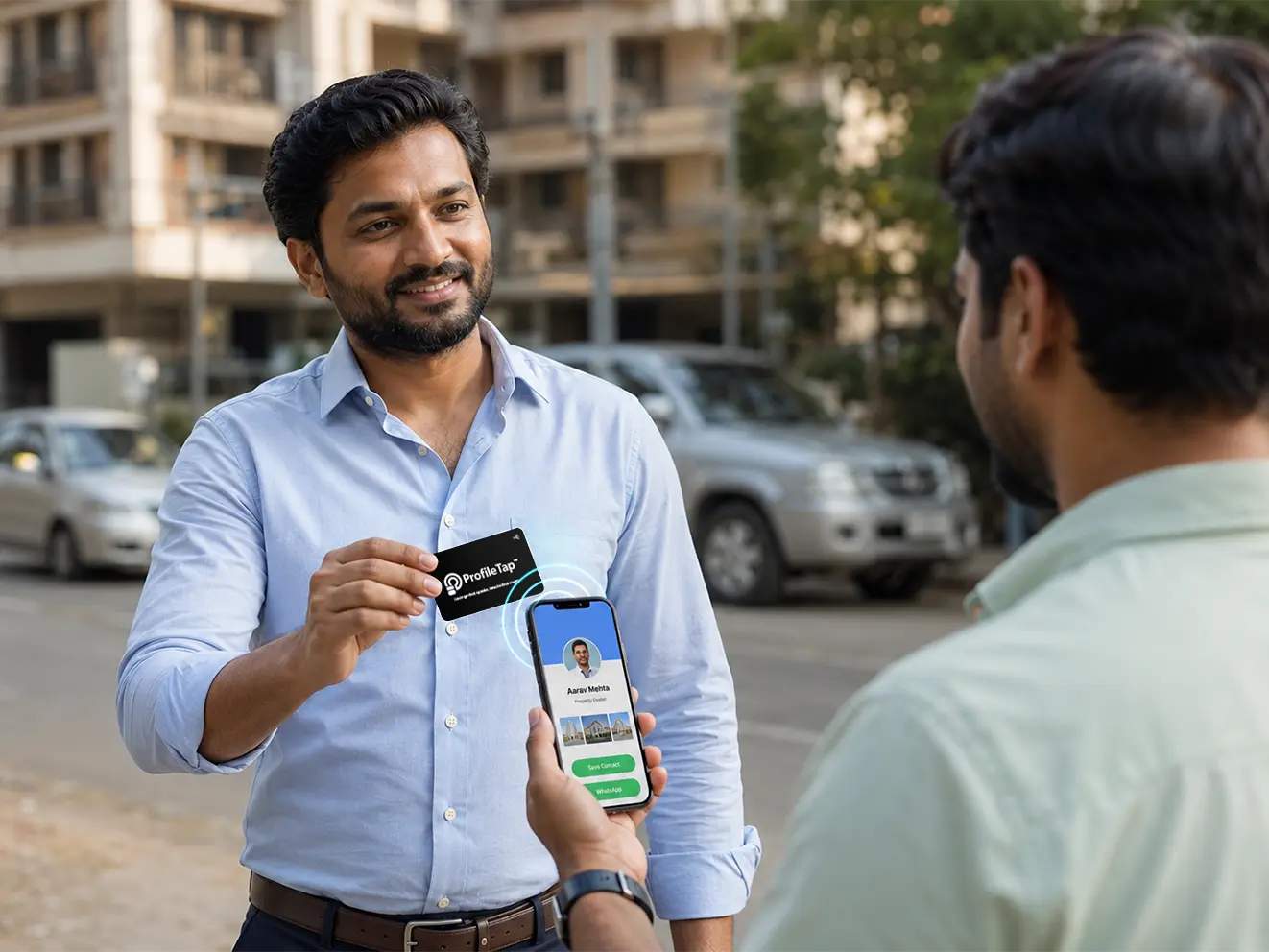 A property dealer tapping an NFC visiting card to share listings with a client.