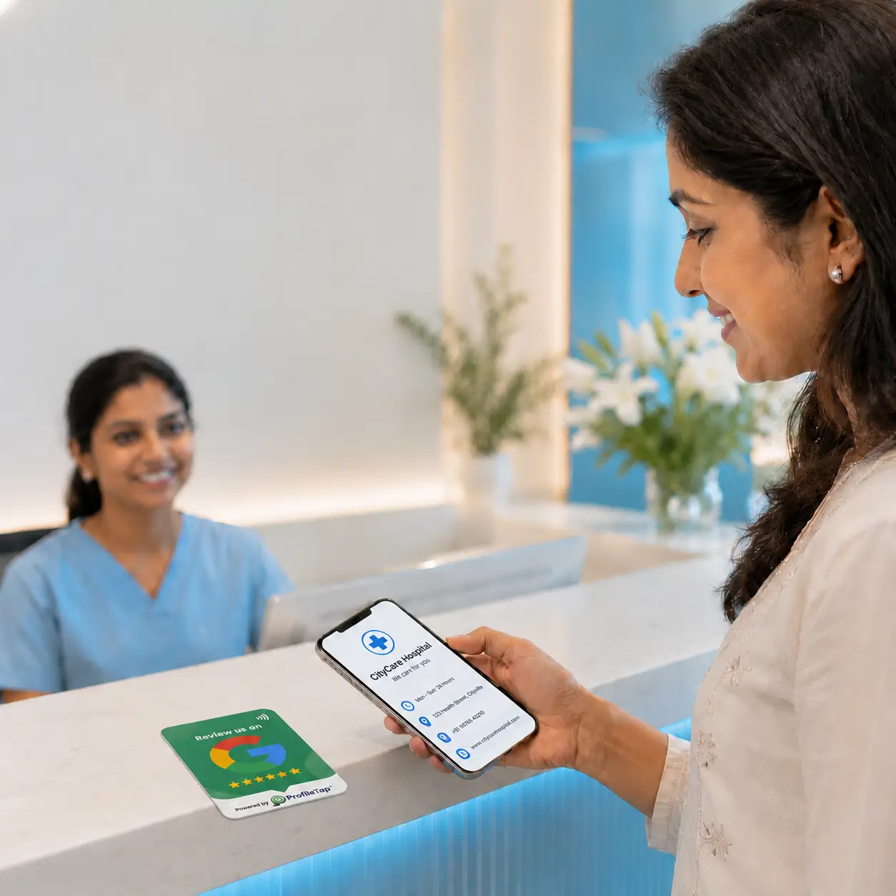 A patient tapping a ProfileTap Google review card at a clinic reception desk in India